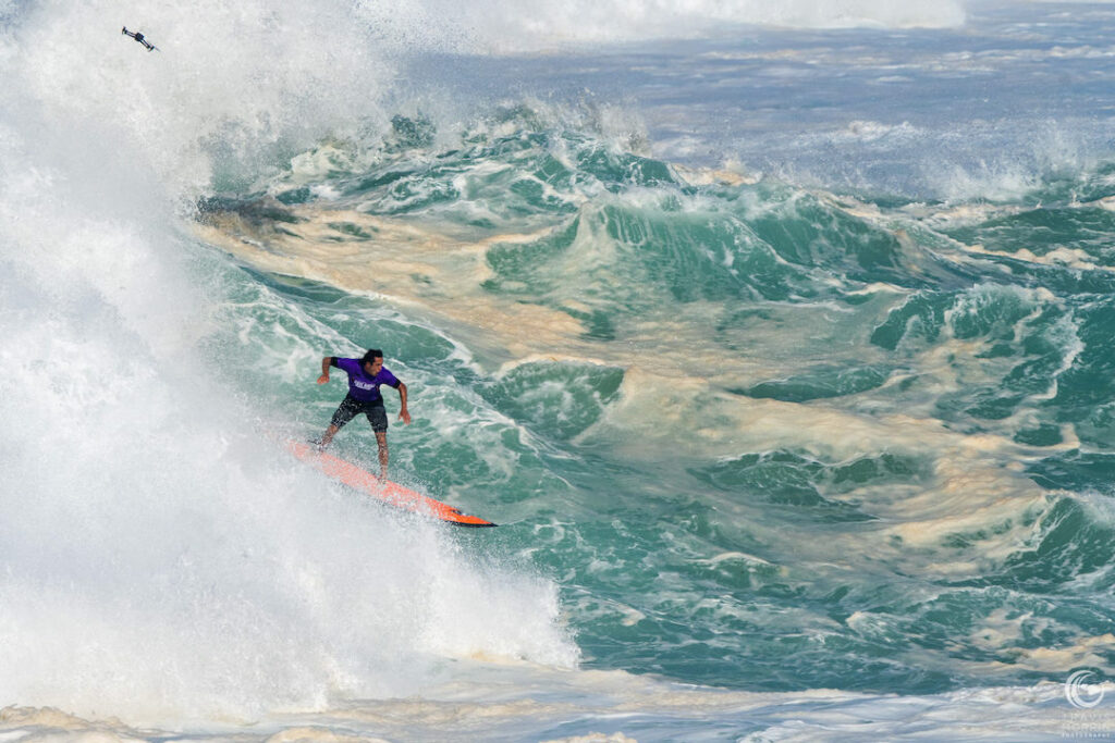 Surfer in the waves at Waimea Bay during The Eddie